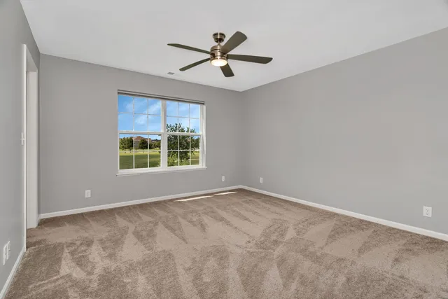 a view of room with window and ceiling fan