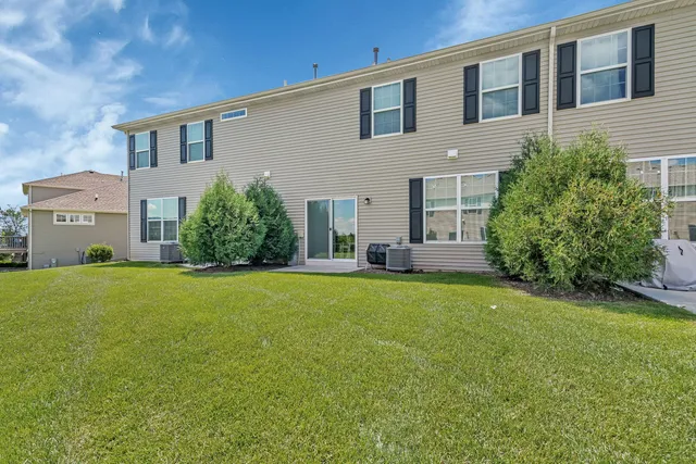 a view of a house with backyard and garden