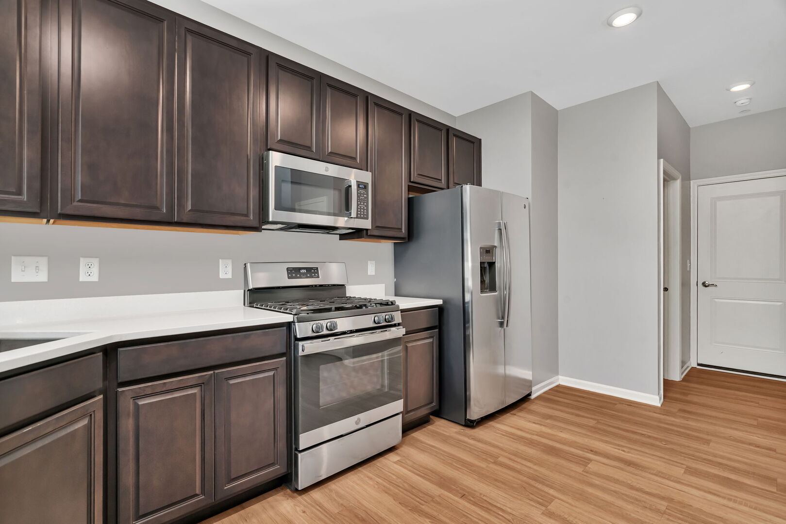 1334 Hawk Hollow Drive Yorkville, IL 60560 - Photo 10 of 28 a kitchen with granite countertop wooden cabinets stainless steel appliances and a wooden floor