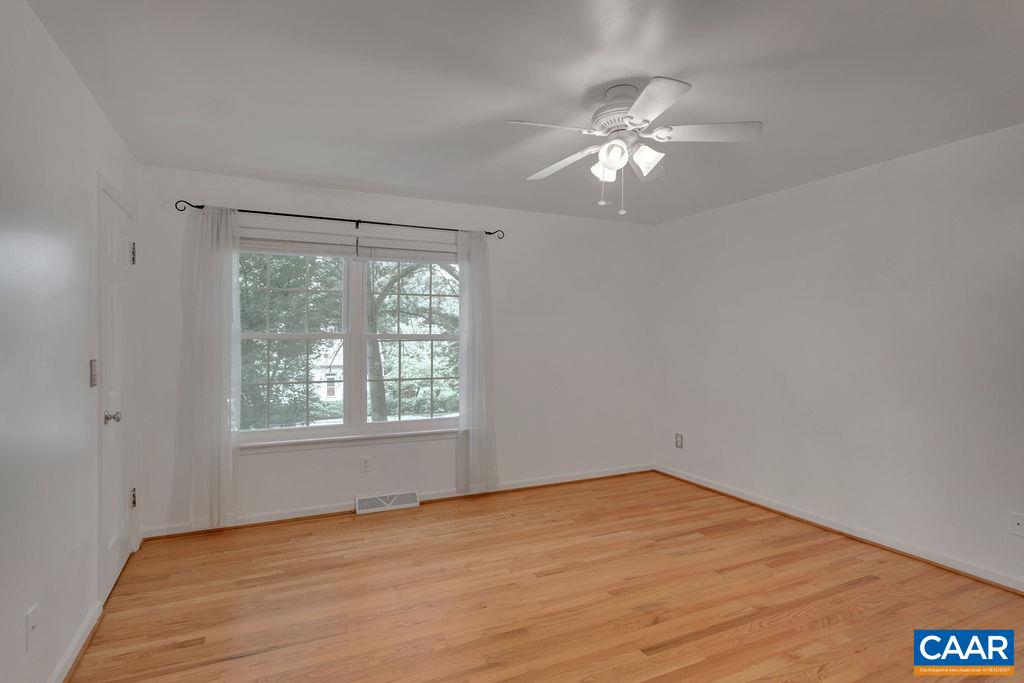 1765 Tinkers Cove Road Charlottesville, VA 22911 - Photo 19 of 44 a view of empty room with wooden floor and fan