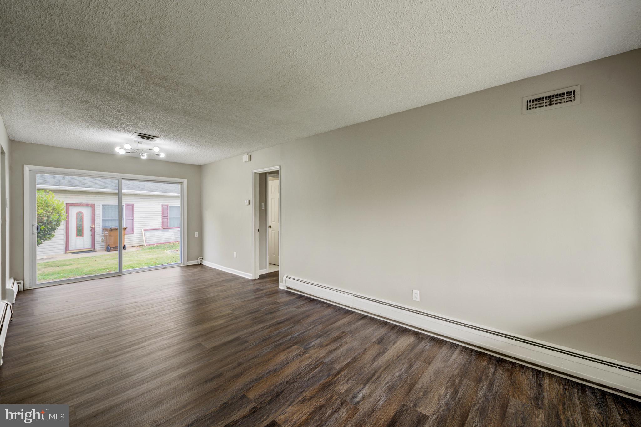4255 Somerton Road Feasterville-Trevose, PA 19053 - Photo 11 of 37 an empty room with wooden floor and windows
