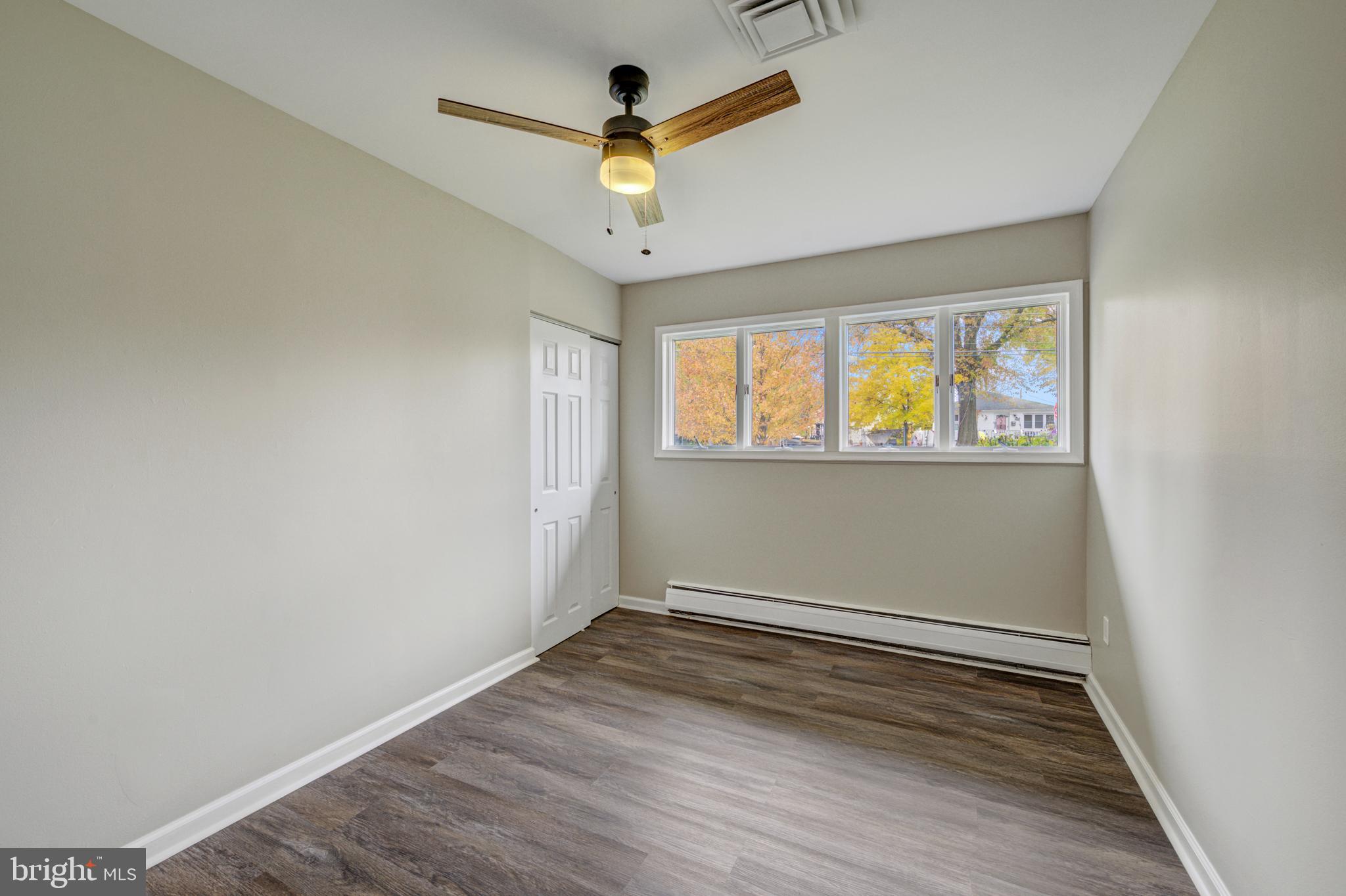 4255 Somerton Road Feasterville-Trevose, PA 19053 - Photo 18 of 37 an empty room with wooden floor and windows
