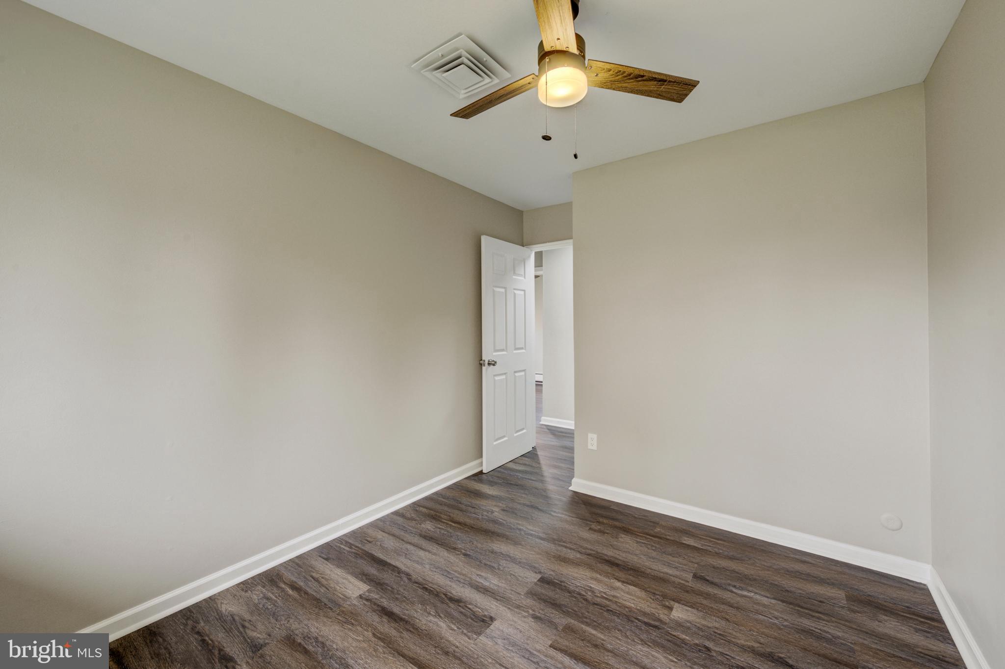4255 Somerton Road Feasterville-Trevose, PA 19053 - Photo 19 of 37 an empty room with wooden floor and windows