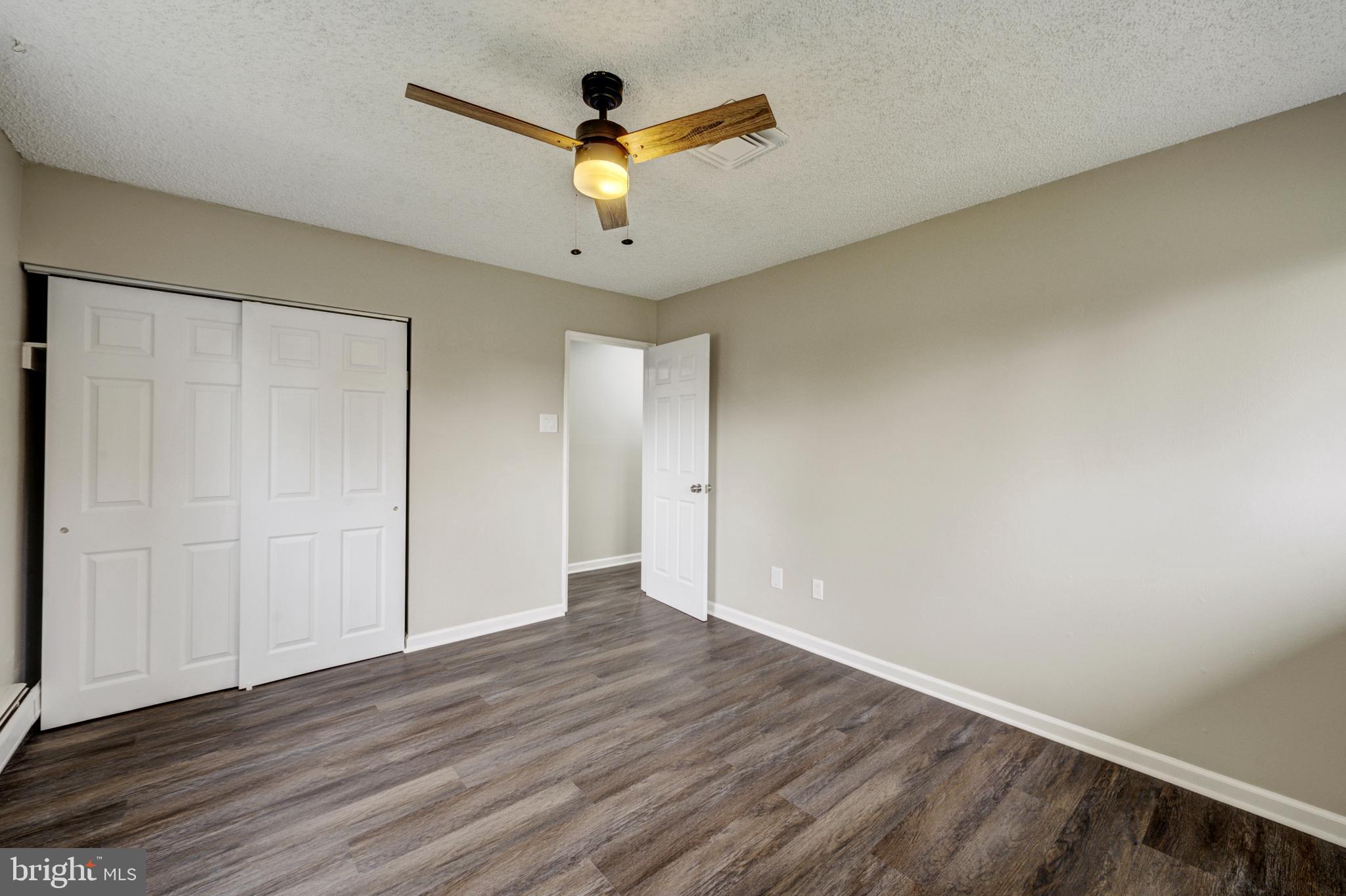 4255 Somerton Road Feasterville-Trevose, PA 19053 - Photo 21 of 37 an empty room with wooden floor and windows