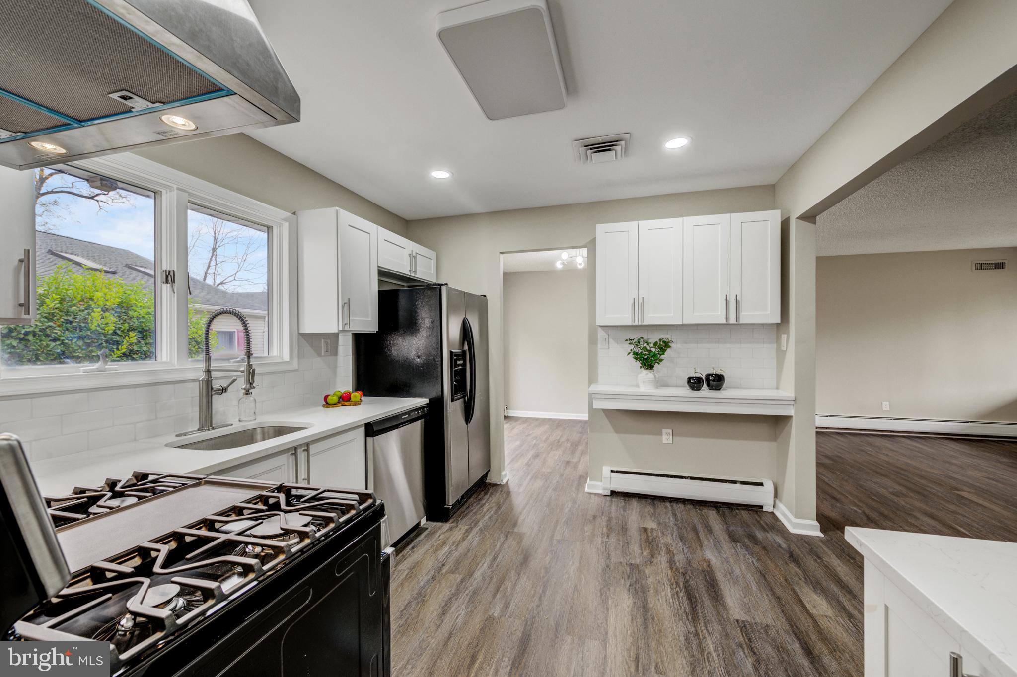 4255 Somerton Road Feasterville-Trevose, PA 19053 - Photo 6 of 37 a kitchen with a stove a sink and a refrigerator