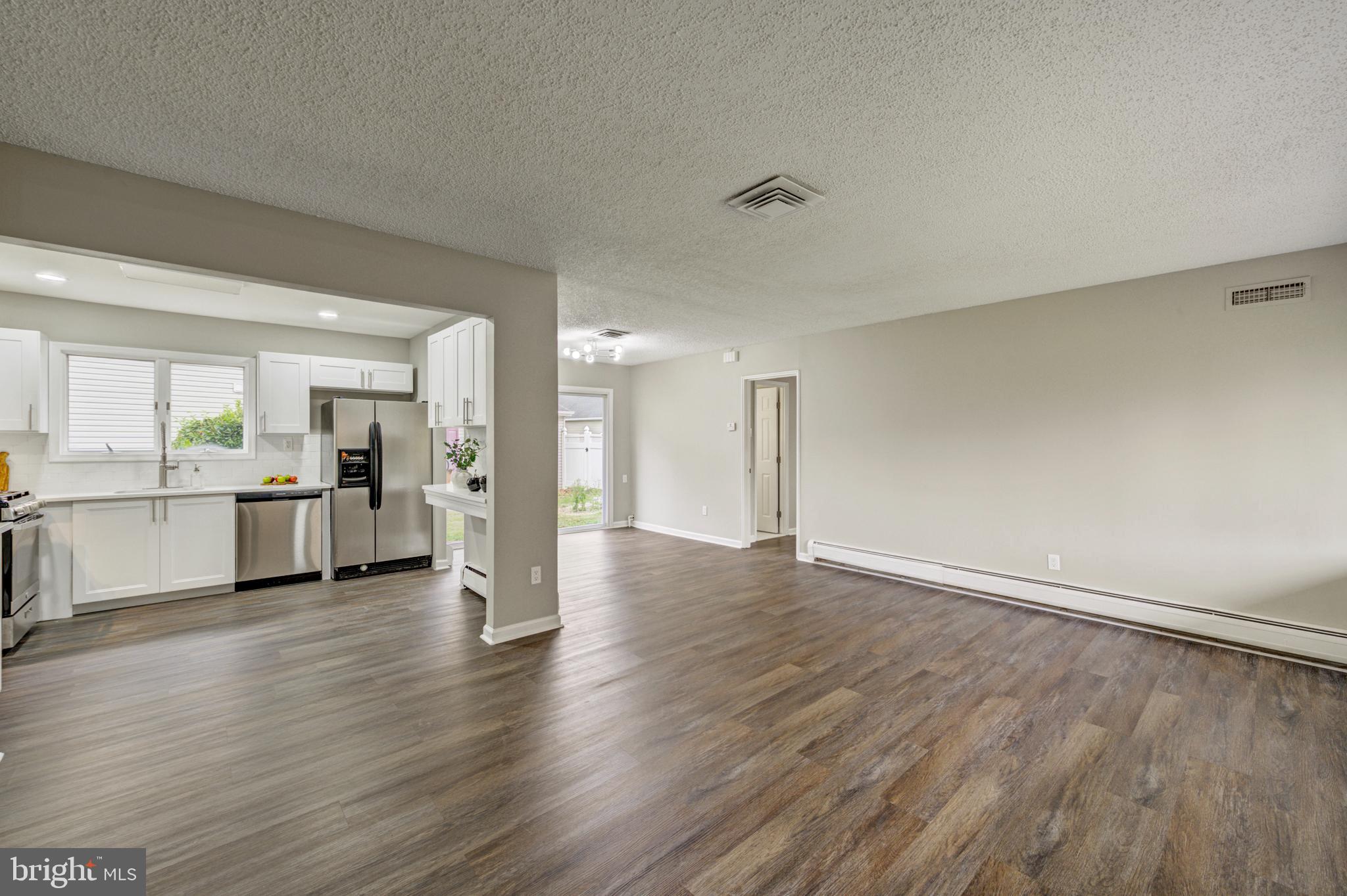 4255 Somerton Road Feasterville-Trevose, PA 19053 - Photo 10 of 37 a view of a kitchen with wooden floor and windows