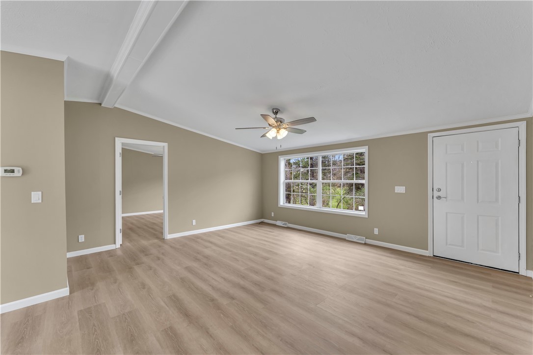 12082 State Highway Walton, NY 13856 - Photo 10 of 28 Living room with vaulted ceilings and laminate flooring