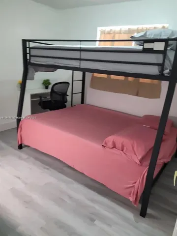 a bedroom with a bed and a desk