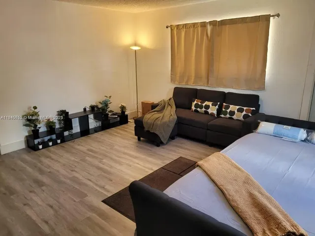 a bedroom with bed and wooden floor