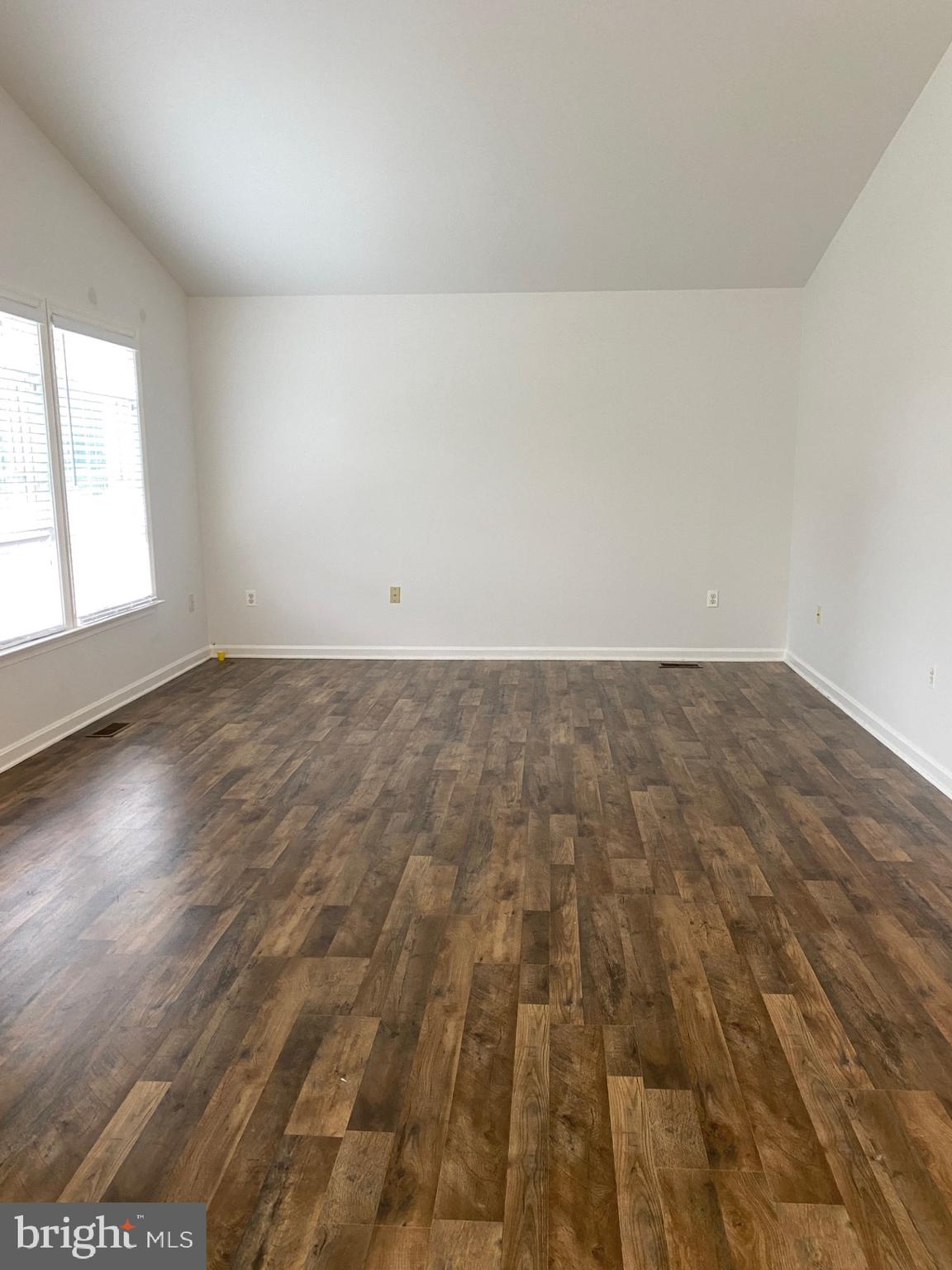 4 Wolf Avenue Reisterstown, MD 21136 - Photo 14 of 39 an empty room with wooden floor and windows