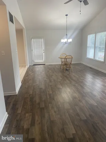a very nice looking room with wooden floor and a window