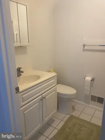 an empty room with wooden floor and white walls