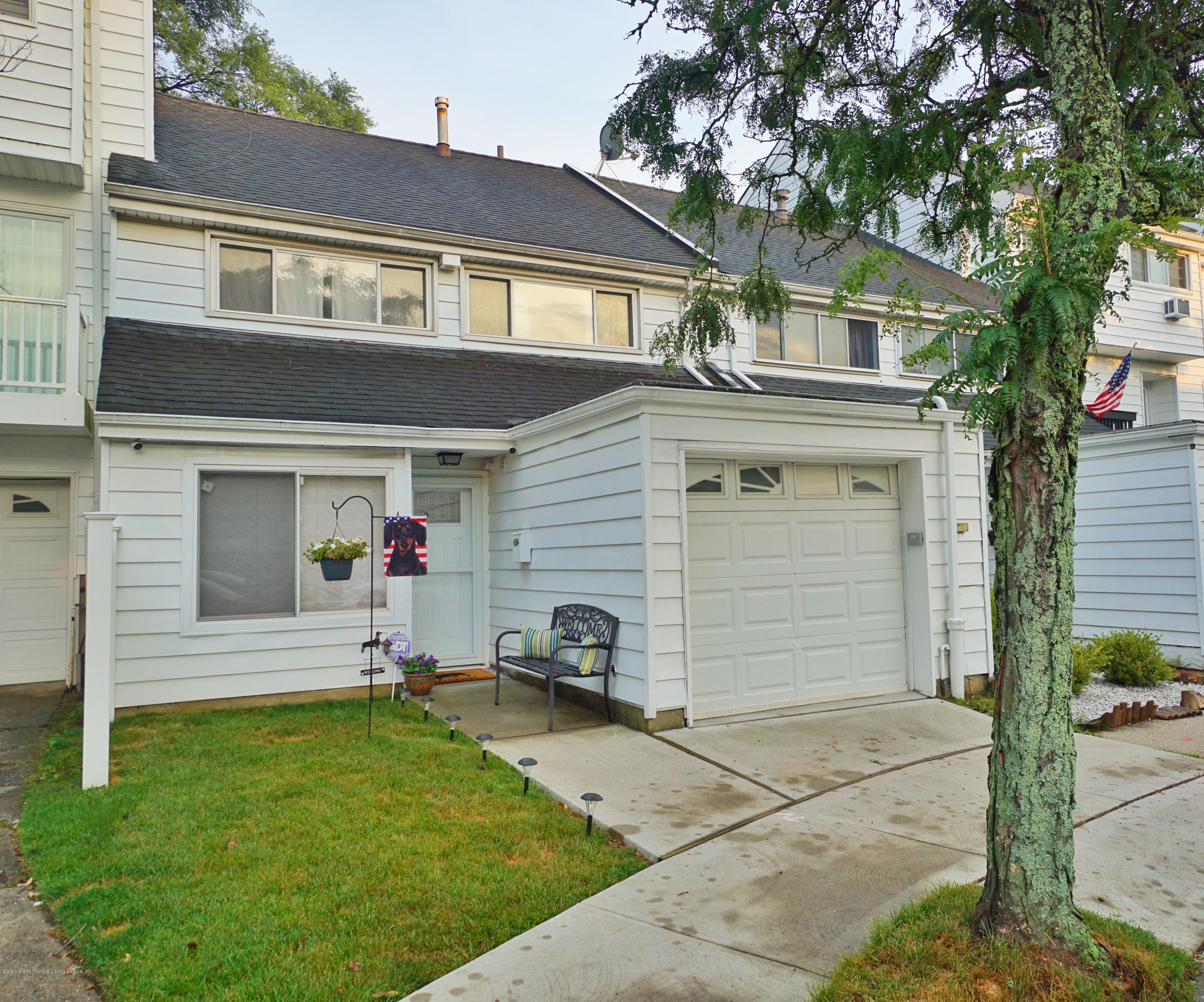 a view of a house with a yard and garage