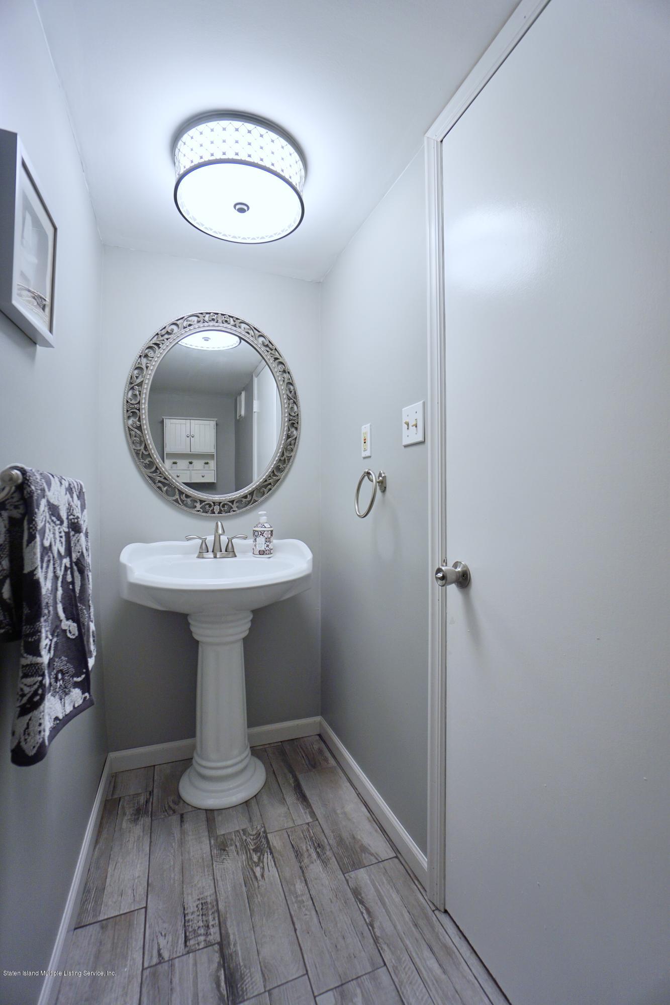 43 Forest Green Staten Island, NY 10312 - Photo 11 of 30 a bathroom with a sink toilet and mirror