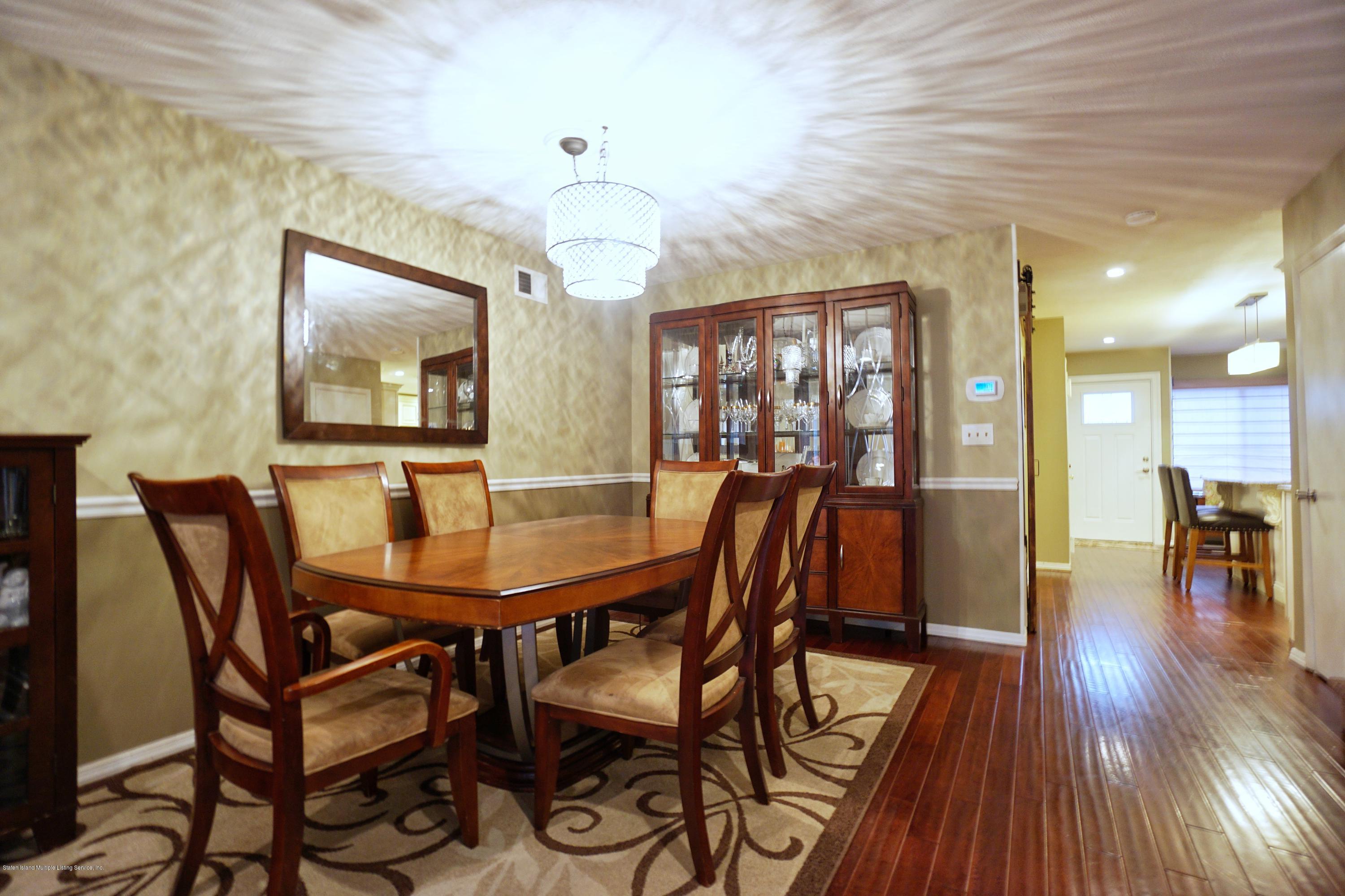 43 Forest Green Staten Island, NY 10312 - Photo 15 of 30 a view of a dining room with furniture and wooden floor