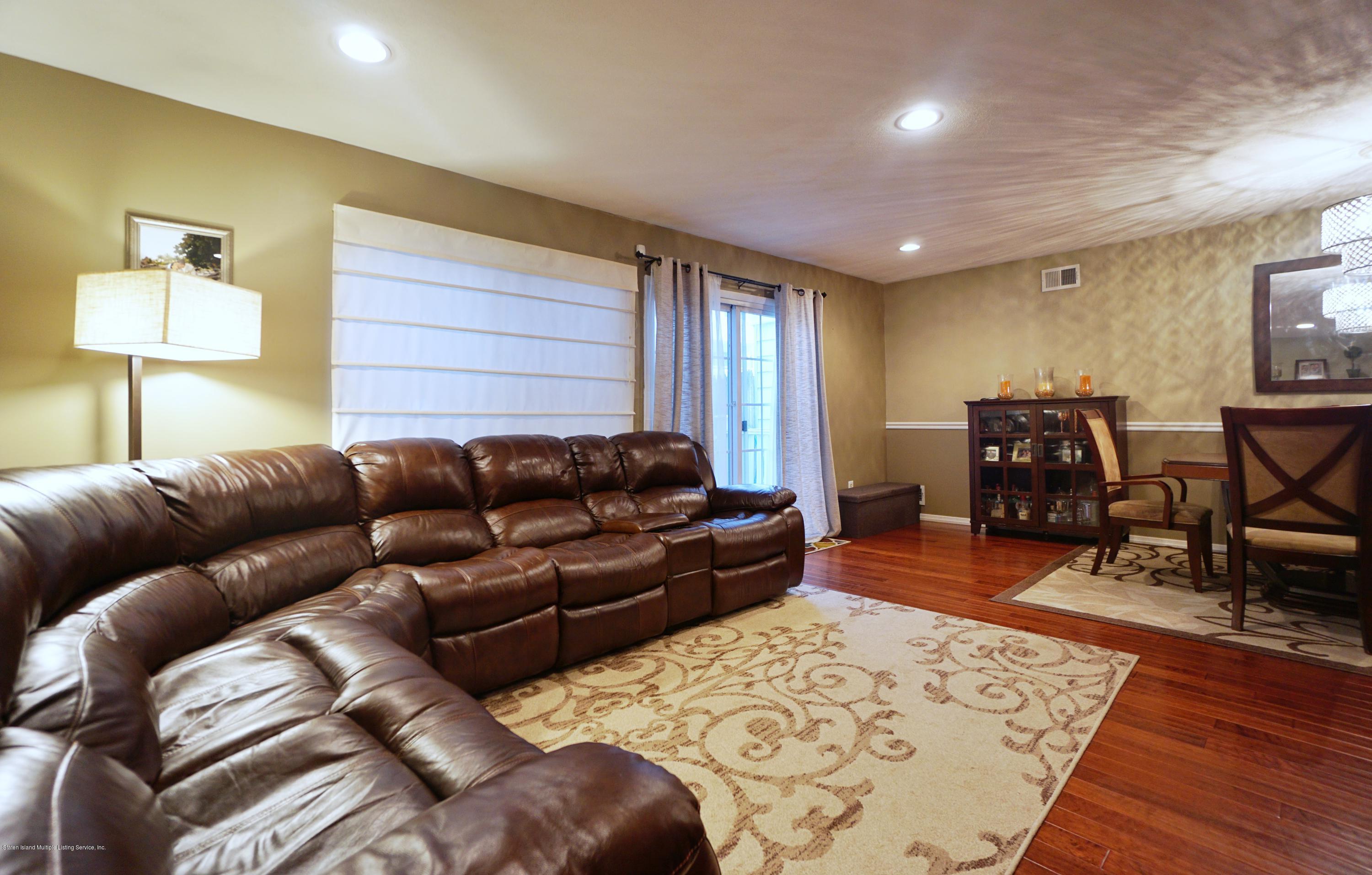 43 Forest Green Staten Island, NY 10312 - Photo 16 of 30 a living room with furniture and wooden floor