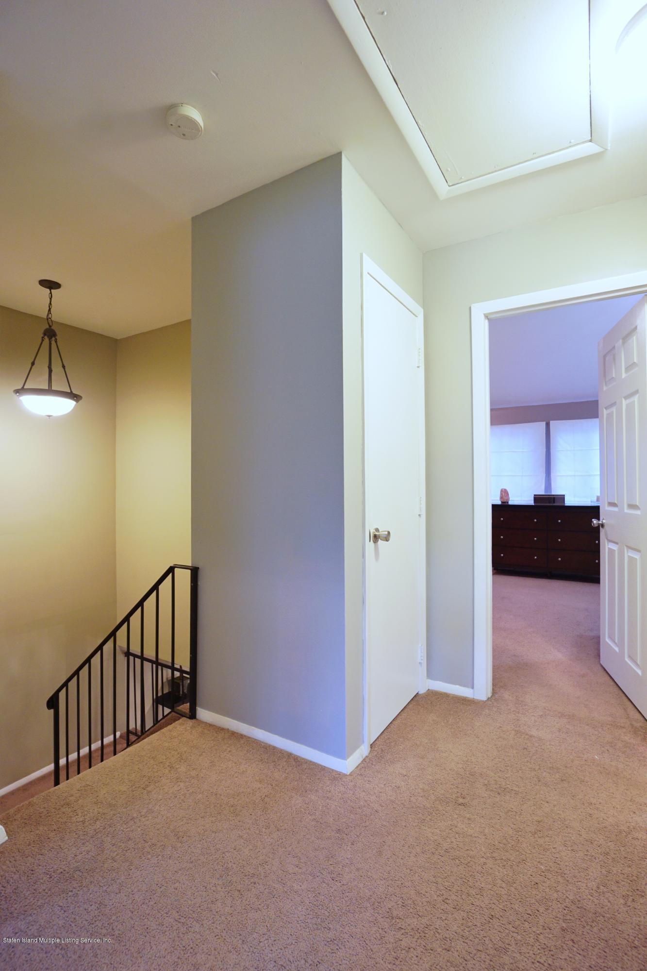 43 Forest Green Staten Island, NY 10312 - Photo 25 of 30 a view of hallway with furniture and a kitchen