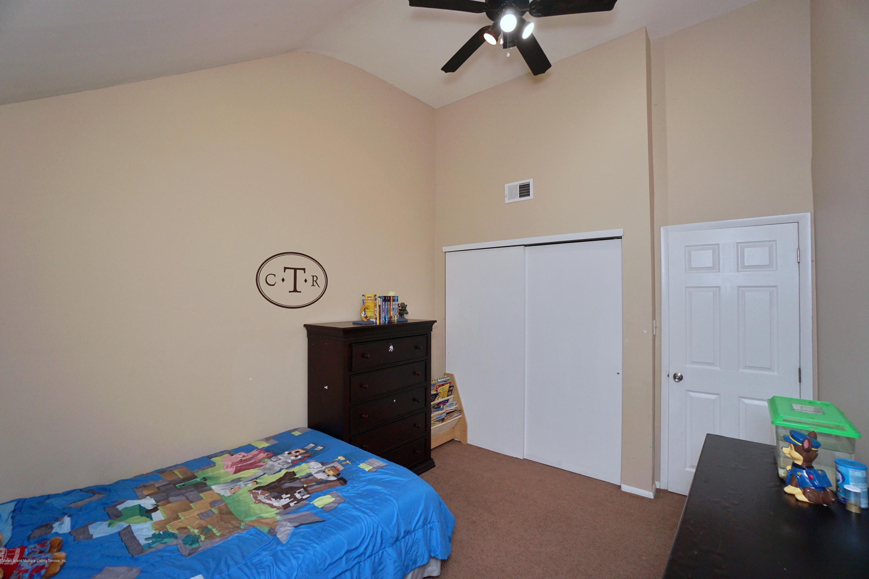 43 Forest Green Staten Island, NY 10312 - Photo 27 of 30 a bedroom with a bed and a dresser