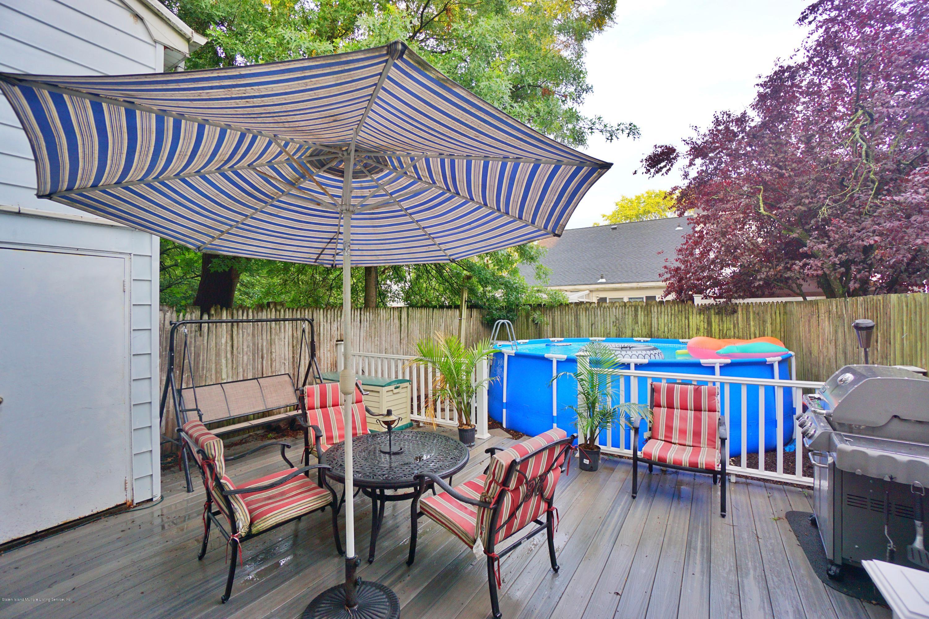 43 Forest Green Staten Island, NY 10312 - Photo 28 of 30 a view of deck with table and chairs a barbeque with wooden floor and fence