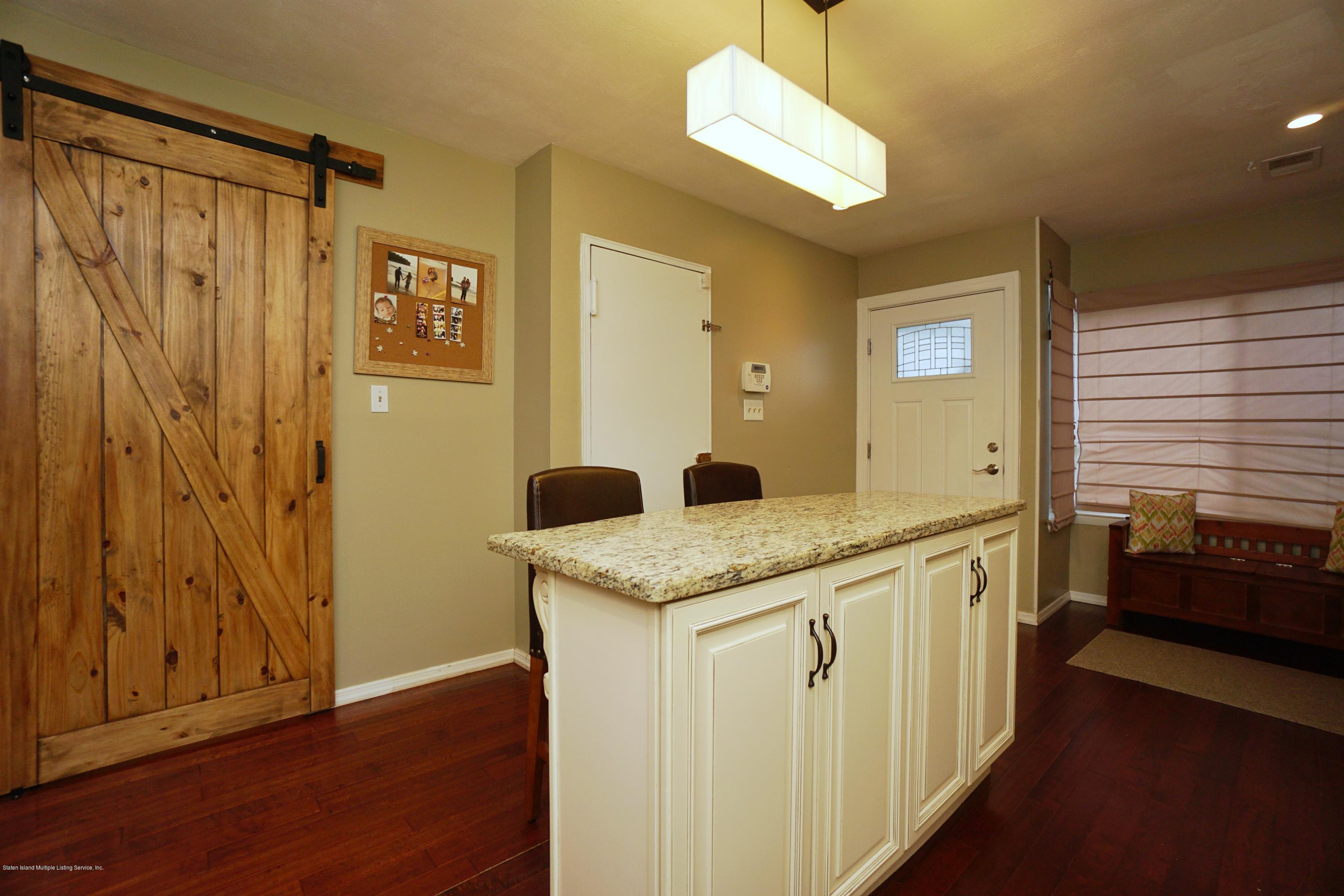 43 Forest Green Staten Island, NY 10312 - Photo 7 of 30 a spacious bathroom with a granite countertop sink and a mirror