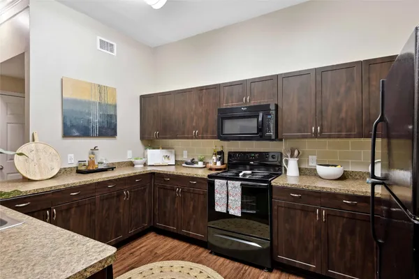 a kitchen with a sink a stove and cabinets