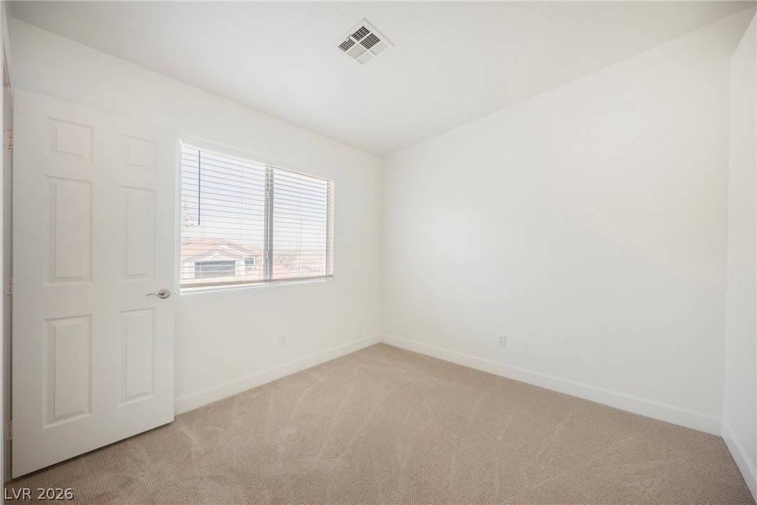 112 Iridescent Street Henderson, NV 89012 - Photo 14 of 24 A well-lit room awaits your personal touch with ample natural light from the large window.