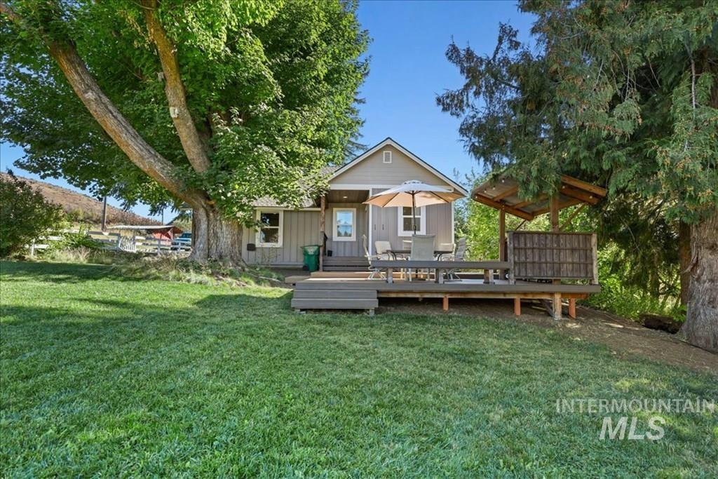 2651 Fruitvale Glendale Road Council, ID 83612 - Photo 15 of 25 Back of house featuring a yard, a deck, and board and batten siding