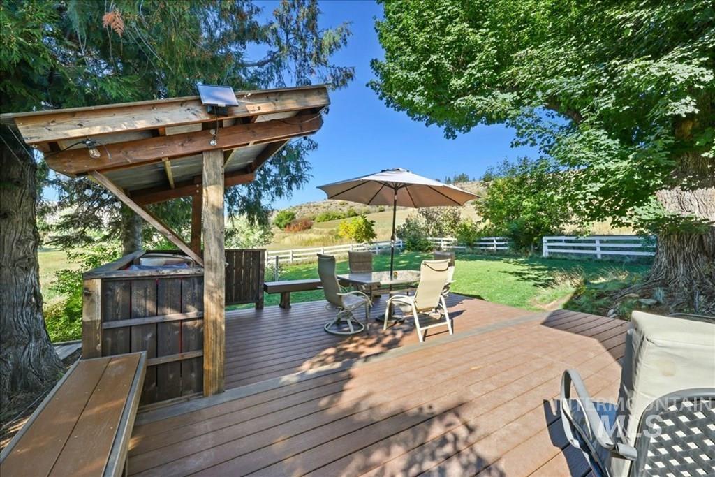 2651 Fruitvale Glendale Road Council, ID 83612 - Photo 16 of 25 Wooden terrace featuring outdoor dining space and a fenced backyard