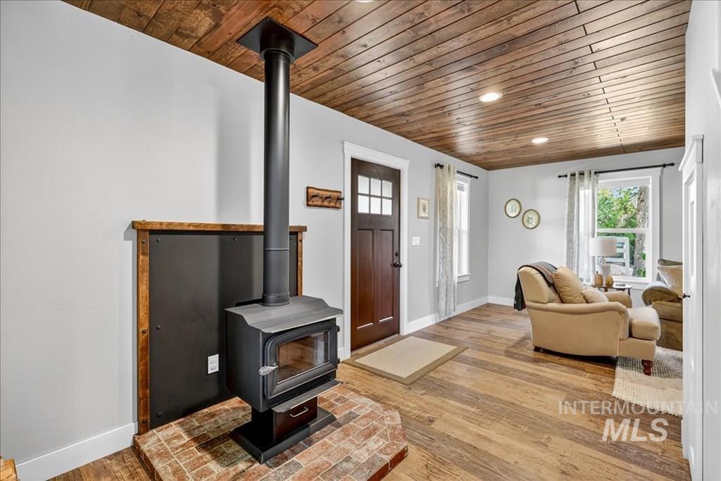2651 Fruitvale Glendale Road Council, ID 83612 - Photo 4 of 25 Living area with wooden ceiling, light wood-style flooring, a wood stove, healthy amount of natural light, and recessed lighting