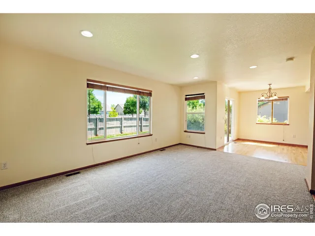 a view of a livingroom with an empty space and a window
