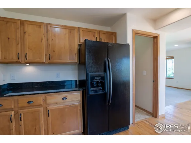 a kitchen with stainless steel appliances granite countertop a refrigerator and a stove