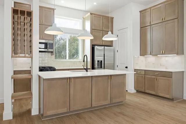 a kitchen with a sink cabinets and window