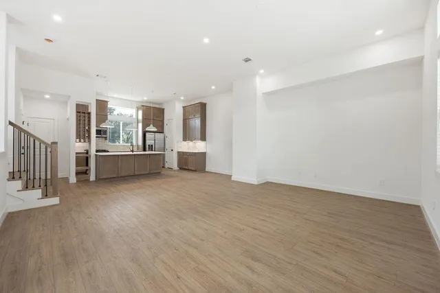 a view of a kitchen with a sink and a refrigerator