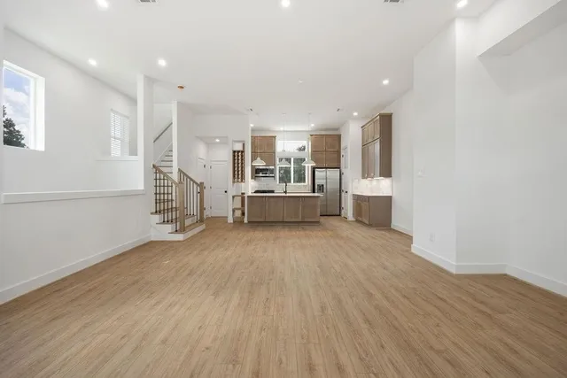 a big room with wooden floor and windows