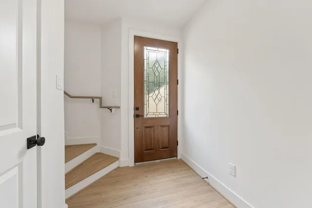 a view of a hallway with wooden floor