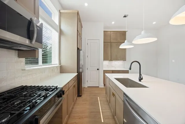 a kitchen that has a sink and a stove