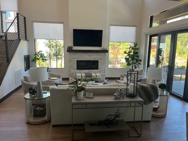 a living room with furniture a flat screen tv and a fireplace