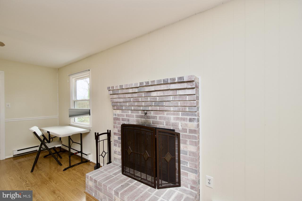 5509 Glenallen Street Springfield, VA 22151 - Photo 11 of 36 a living room with furniture and a fireplace