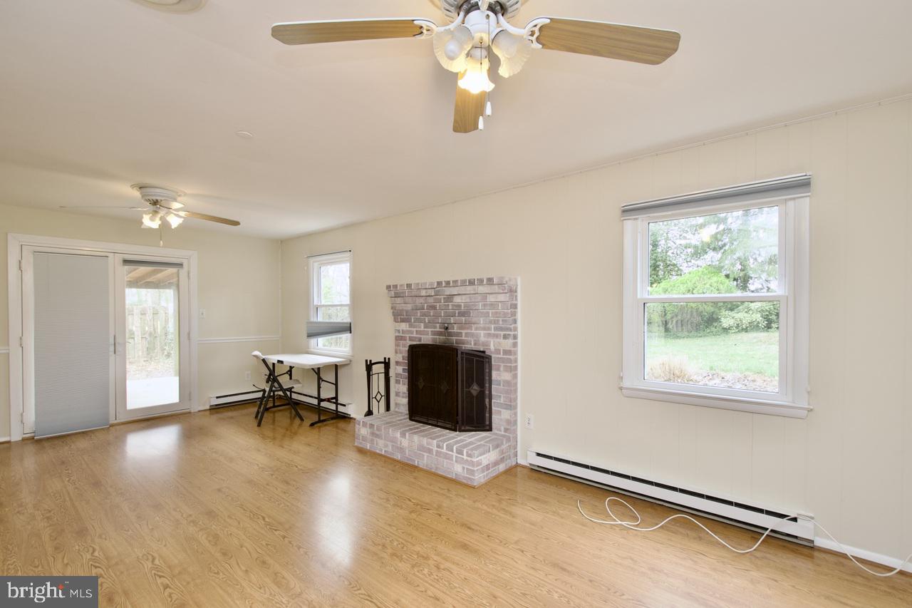5509 Glenallen Street Springfield, VA 22151 - Photo 12 of 36 a living room with furniture and a fireplace