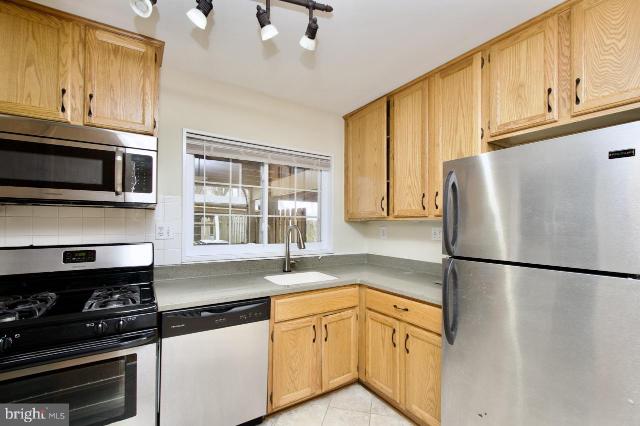 5509 Glenallen Street Springfield, VA 22151 - Photo 15 of 36 a kitchen with granite countertop cabinets stainless steel appliances and a counter space