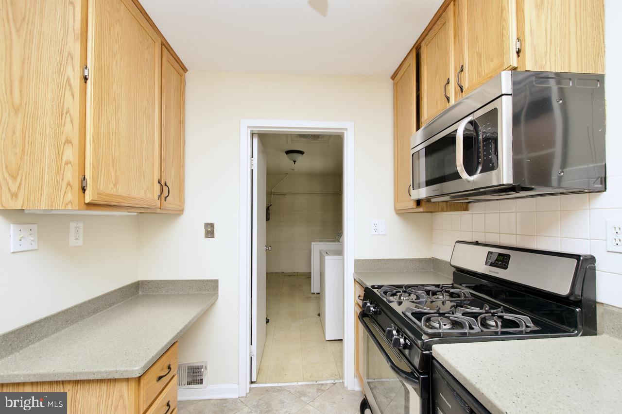 5509 Glenallen Street Springfield, VA 22151 - Photo 16 of 36 a kitchen with stainless steel appliances granite countertop a stove and a refrigerator