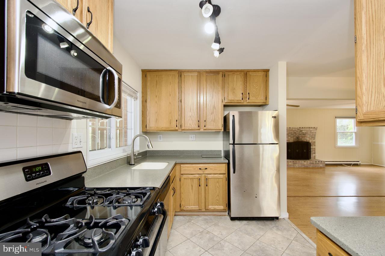 5509 Glenallen Street Springfield, VA 22151 - Photo 17 of 36 a kitchen with a refrigerator stove and microwave