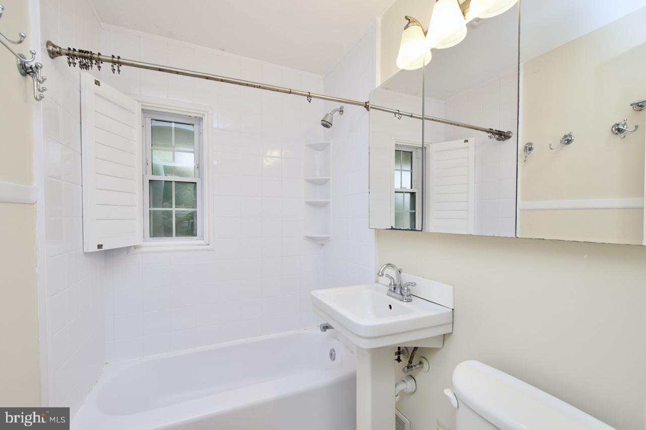 5509 Glenallen Street Springfield, VA 22151 - Photo 23 of 36 a bathroom with a sink a toilet and shower