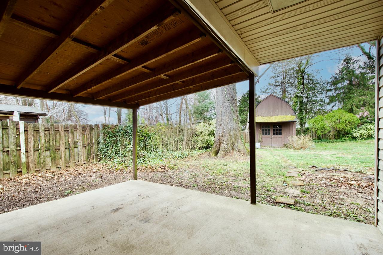 5509 Glenallen Street Springfield, VA 22151 - Photo 29 of 36 a view of a backyard with floor to ceiling window and wooden fence