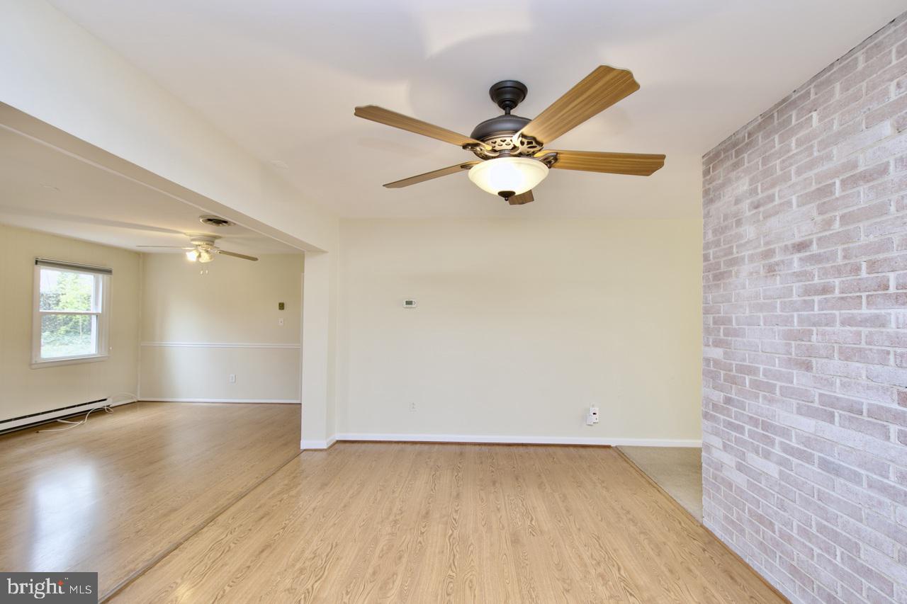 5509 Glenallen Street Springfield, VA 22151 - Photo 7 of 36 an empty room with a window and a ceiling fan