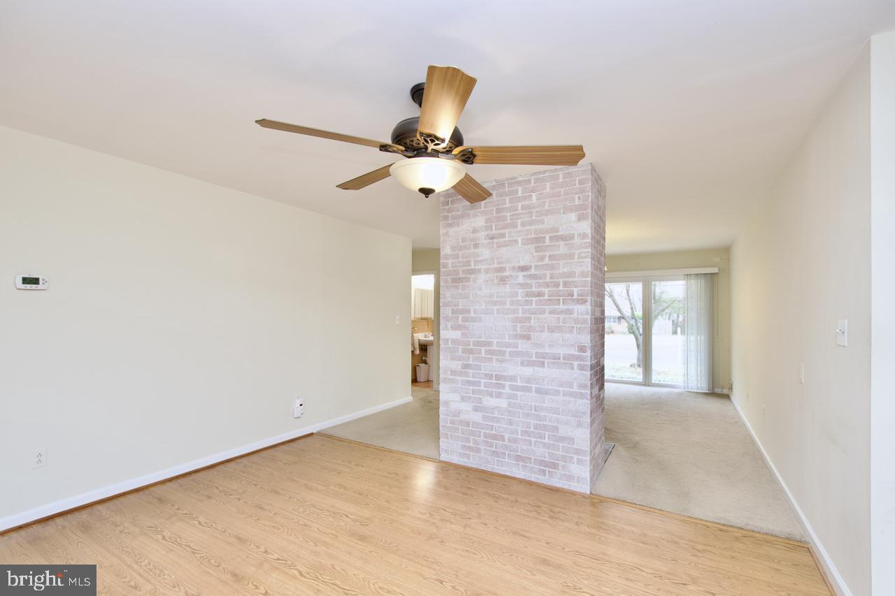 5509 Glenallen Street Springfield, VA 22151 - Photo 8 of 36 a view of an empty room with a ceiling fan and a carpet