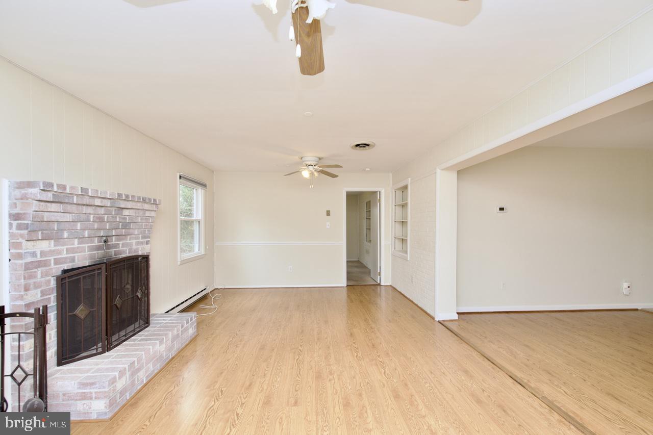 5509 Glenallen Street Springfield, VA 22151 - Photo 10 of 36 an empty room with fireplace and windows