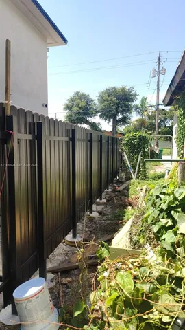 a view of a backyard with table and chairs and wooden fence