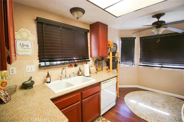 a kitchen with a refrigerator and a stove top oven