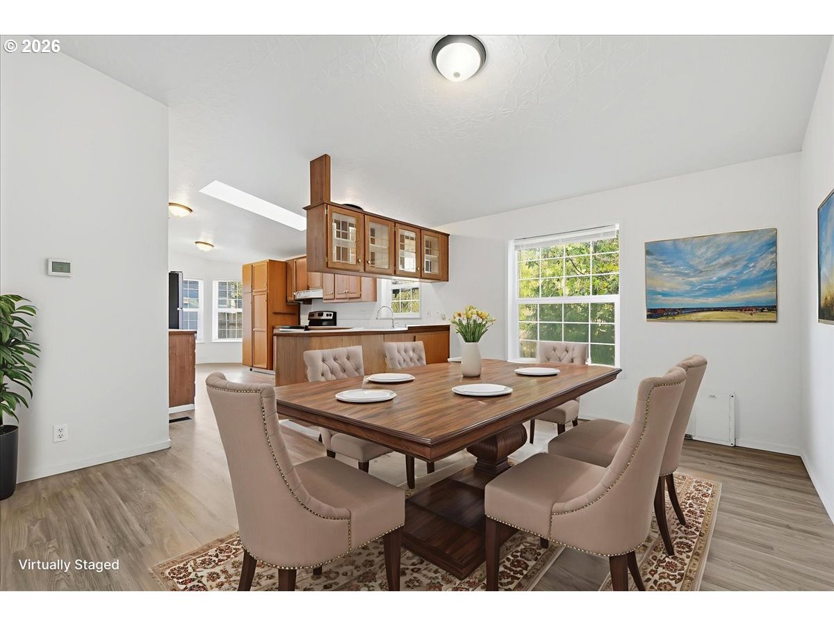 28 South Gee Creek Loop Ridgefield, WA 98642 - Photo 11 of 38 a view of a dining room with furniture window and wooden floor